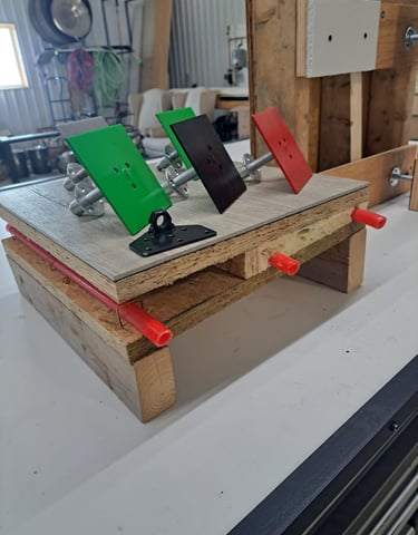 Mounted color-coded anchor plates displayed on a construction test setup for framing and insulation systems