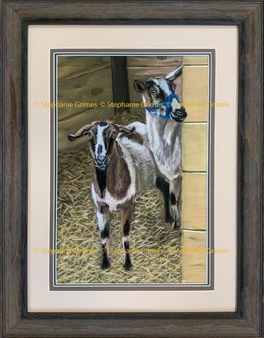 Framed pastel drawing of two goats standing on straw in a barn by artist Stephanie Grimes.