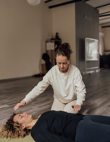 a woman in a white shirt is stretching out her arms and hands