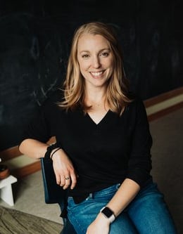 a woman sitting on a chair in a room