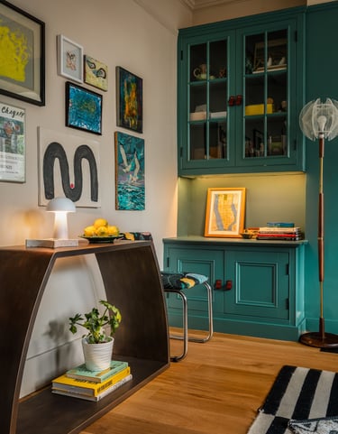 maximalist home office with gallery wall, teal storage, mid-century touches