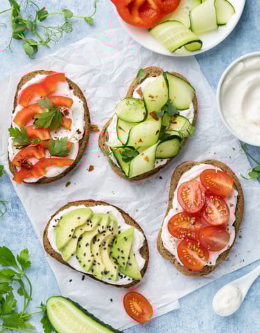 healthy vegetarian bruschetta with cherry tomatoes, avocado, cucumber, paprika and Ricotta 