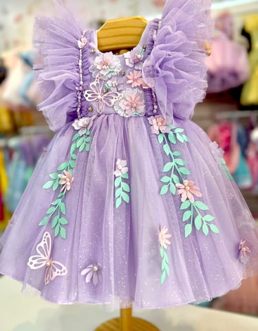 Purple butterfly tulle flower girl dress with 3D floral appliqués and ruffled sleeves.