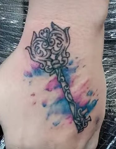 a tattoo style key water color on a hand