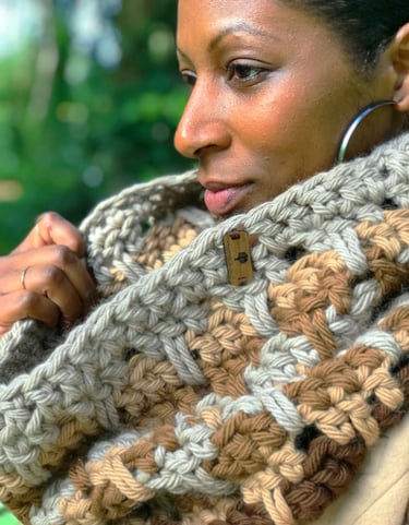 A woman wearing a chunky crochet cowl around her neck