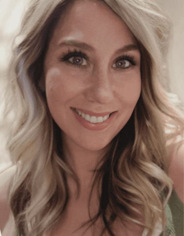 a woman with blonde hair and a green dress