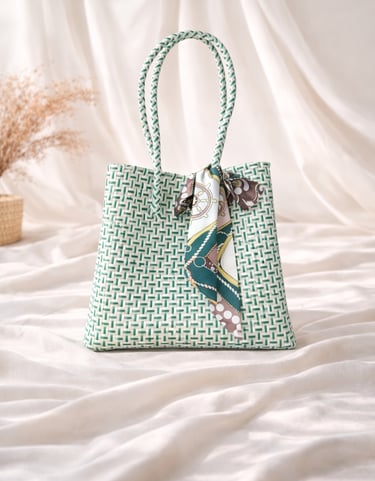 Handwoven white and green plastic tote bag handmade from recycled materials by Indonesian artisans