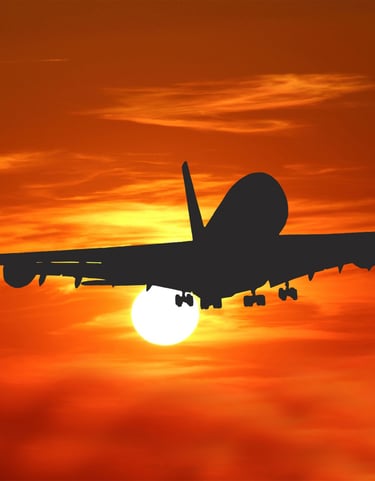 Airline flight heading into sunset