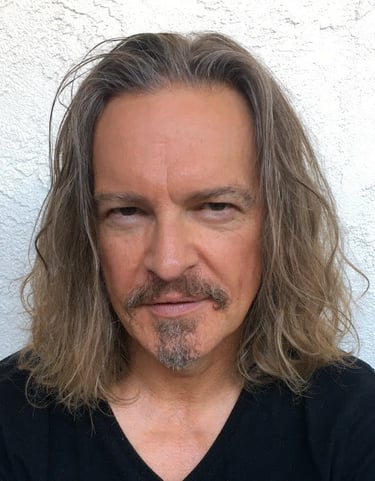 Headshot of Todd Long with long hair, moustache, and goatee