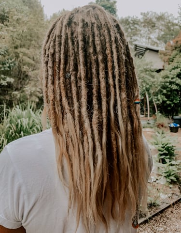a woman with long hair and dreadlocks on her head