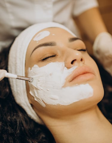 a woman getting a facial in a beauty salon