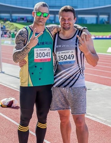 two male athletes posing for a photo