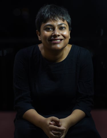 This is an image of the therapist. With a black background and clothing, a wide welcoming smile