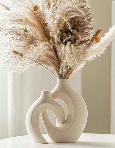 Modern ceramic vase set of 2 styled with dried pampas grass on a table, featuring neutral home decor in minimalist interior.