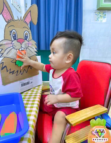 a young child is playing with a cardboard box