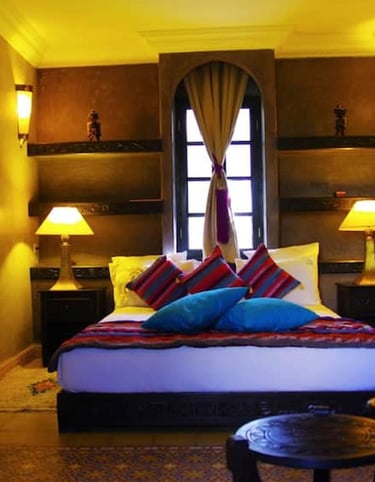 a bedroom with a bed and a chair