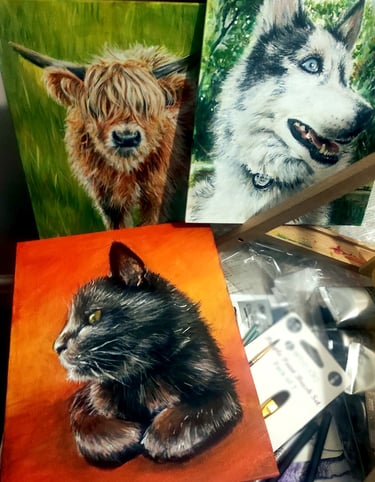 An assortment of paintings of animals in bright acrylic colours, a highland cow, a dog, and a cat