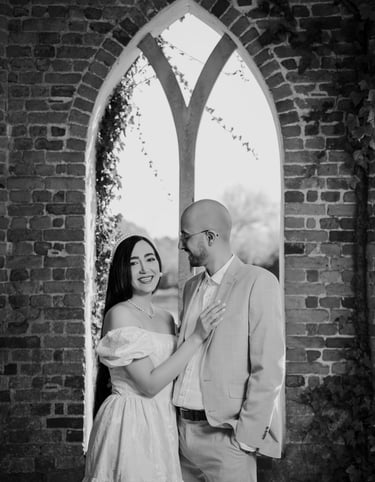 Couple standing in a brick archway during their Surrey engagement shoot by Fred Art Studio.