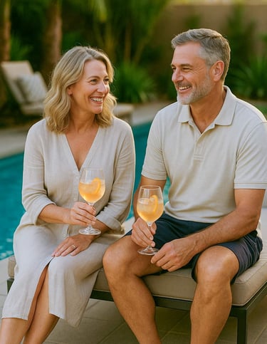 Smiling couple by pool during sunset, representing client satisfaction and Piscus Pools' $200 referral program