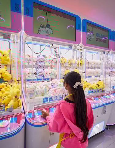 Young girl playing claw machines