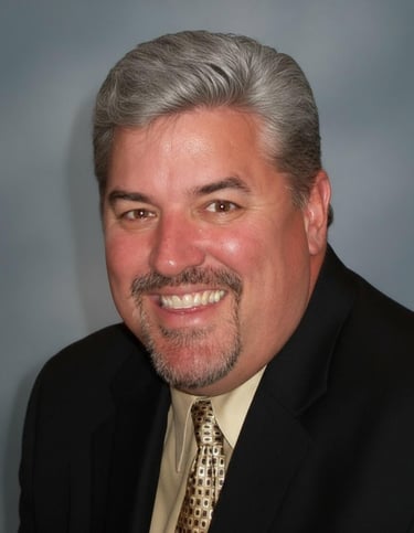 a man in a suit and tie smiling