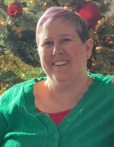 Woman With Green Shirt Christmas Tree Behind Her