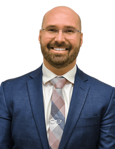 man in a suit with glasses wearing a tie