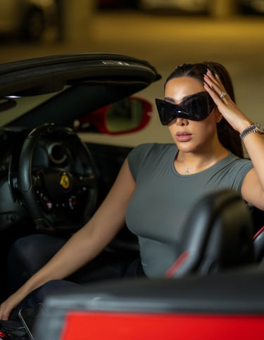 Close-up of model wearing sunglasses inside luxury car, captured by Fred Art Studio.