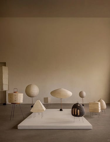 Display of Isamu Noguchi Akari lamps showing soft paper lighting and sculptural forms for calm inter