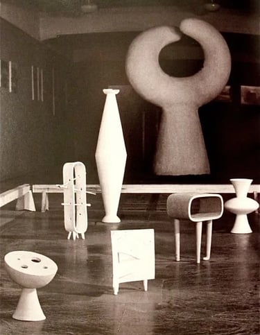 Historic gallery display of Isamu Noguchi sculptural furniture and abstract forms in a modern interi