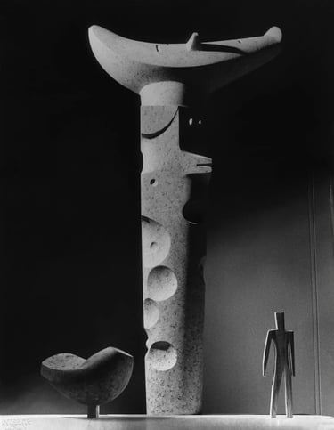 Black and white view of Isamu Noguchi sculptures with organic shapes and quiet modern gallery atmosp