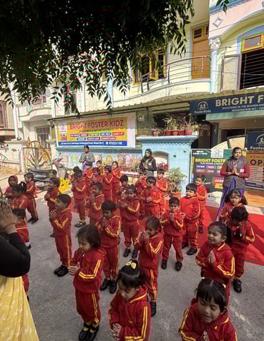 Students in red uniforms pray during morning assembly at Bright Foster Kidz preschool in India.