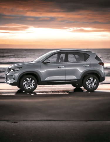 a silver kia sonet parked on the beach