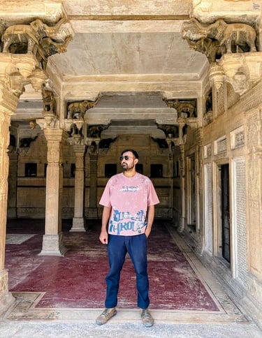 Traveler posing gracefully between the elephant columns of Baradari at Chhatar Mahal, Bundi, capturing the charm of royal-era
