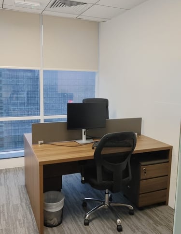 a desk with a computer and a laptop