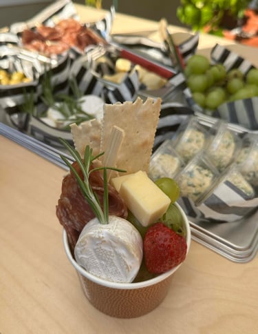 a charcuterie cup with cheese, meat and fruit