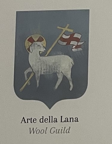 a medieval guild emblem of a sheep carrying a white flag with a red cross