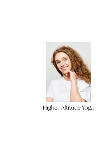 Portrait of a smiling yoga student with curly hair at Higher Altitude Yoga studio.