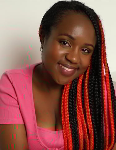a Black woman with a pink top and cardigan, and black and red hair