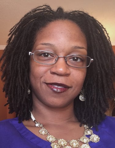 a woman with glasses and a necklace with a necklace