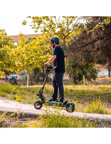a man riding a scooter on a sidewalk