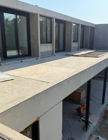 a truck parked in front of a building with a green tarp