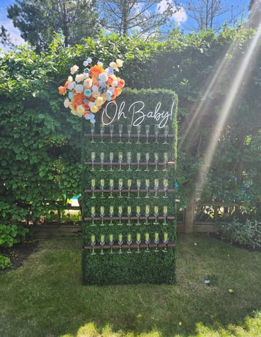 grass champagne wall with tropical floral arrangement