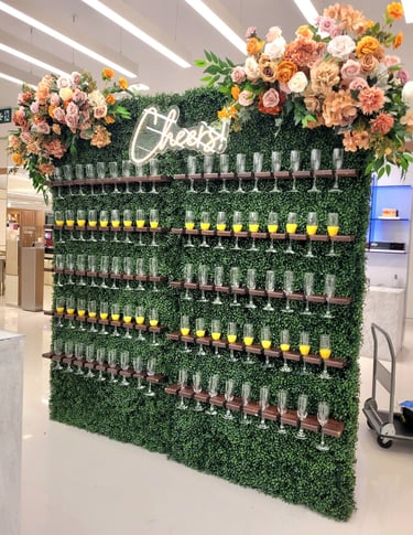 doubl champagne wall of flowers and wine glasses on display