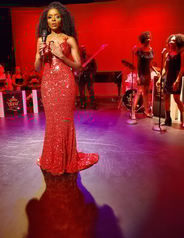 a woman in a red dress standing in front of a microphone