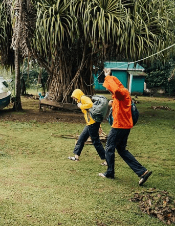 a man and a woman are flying a kite