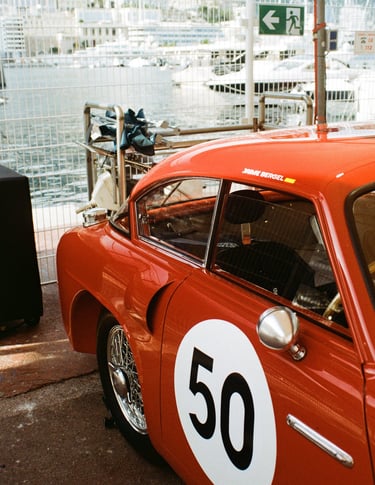 a red race car parked in the paddock