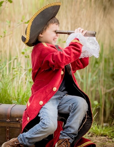Young boy dressed as a pirate for storytelling photography session
