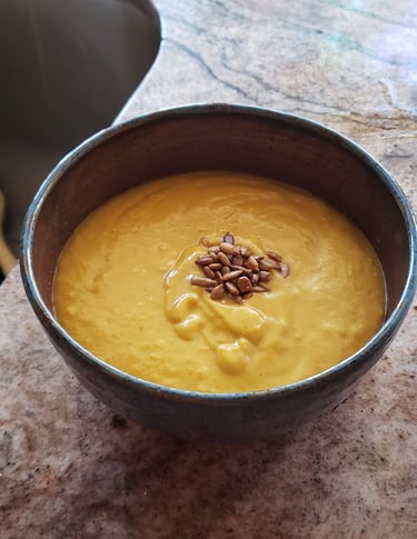 a bowl of soup with sunflower seeds in it