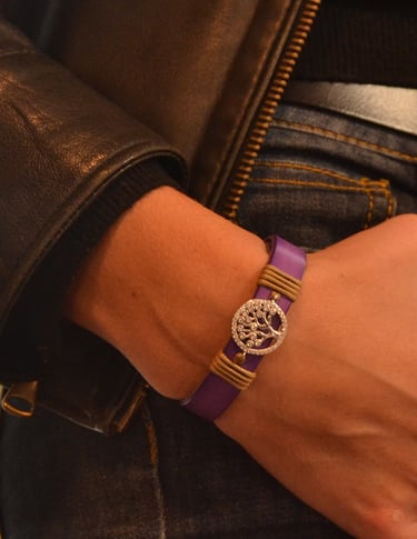 a woman's wrist wearing a purple bracelet